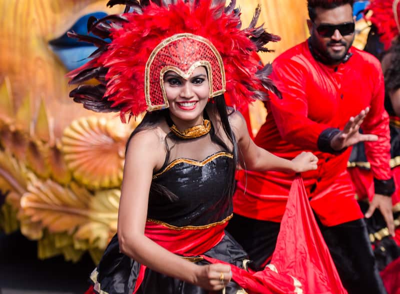 A performer dancing with her co partner during Goa Carnival.